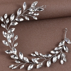 Détail de la vigne à cheveux mariée argentée avec cristaux marquise sur cuir sombre
