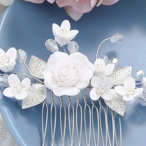 Elegant bridal hair comb with white resin flowers, silver metal leaves, and crystal beads