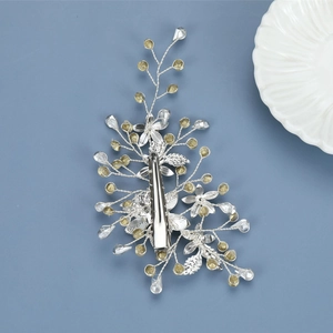 Detailed close-up of handmade silver leaf bridal hair clip with crystals and beads