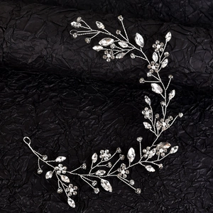 Detail of silver bridal hair vine with marquise rhinestones and metal flowers
