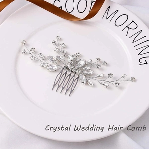 Exquisite silver bridal hair comb featuring sparking crystal clusters on a ceramic plate