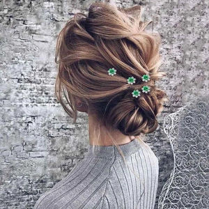 Elegant set of five green rose flower U-shaped hair pins styled in a sophisticated updo