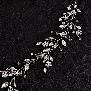 Macro detail of bridal hair vine with silver alloy wire, crystals and white pearls