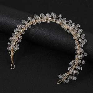 Exquisite bridal headband with gold wires and clear crystal beads on black display