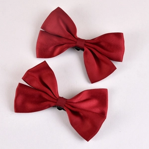 Pair of elegant red satin bow shoe clips with polished texture for wedding bridal accessories