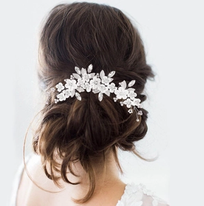 Elegant bridal headpiece with white clay flowers and silver leaf vine for wedding hairstyles