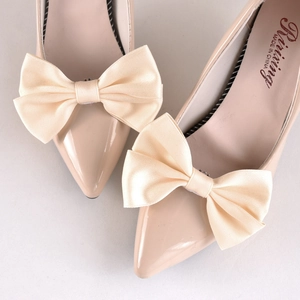 Elegant pointed toe stiletto pumps with large satin bow decoration in nude beige