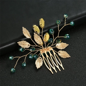 Golden bridal hair comb with emerald green crystals and metallic leaf ornaments