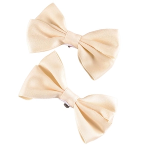 Close-up of elegant champagne satin bow shoe clips with silver metal attachment clips
