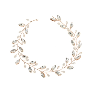 Detail of rose gold bridal hair vine with crystal marquise stones and white faux pearls