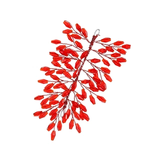 Detail view of handcrafted red crystal beads woven on wires for festive hair styling