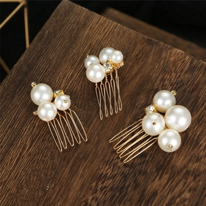 Three-piece gold bridal hair comb set featuring white pearls and sparkling rhinestones
