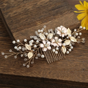Handmade golden flower hair comb with pink blossoms, pearls and crystals on wood