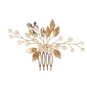 Detail of handmade gold leaf hair comb with emerald crystals and beaded wire branches