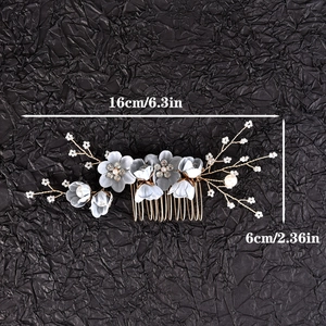 Detail of blue satin flower hair comb with rhinestones and white pearls on gold wire