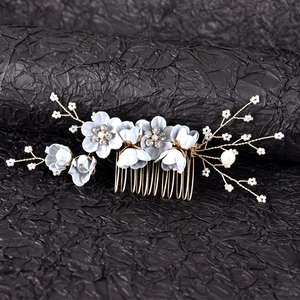 Detailed close-up of handmade blue fabric flowers with rhinestones and white pearls