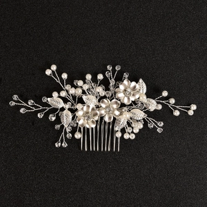 Detail view of handmade silver hair comb with crystal flowers and bridal pearls