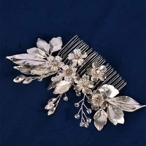 Close-up of bridal flower hair comb with silver alloy petals and sparkling rhinestones