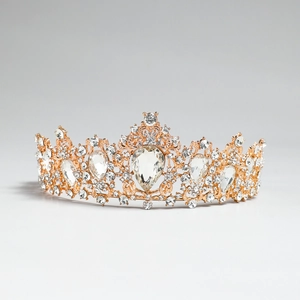 Detailed macro shot of ornate golden bridal crown with drop-shaped crystals and rhinestones