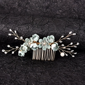 Detail view of handmade floral hair comb with light cyan fabric flowers and pearls