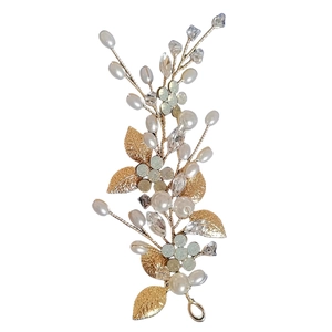 Set per capelli da sposa dorato con perline bianche e cristalli su sfondo bianco