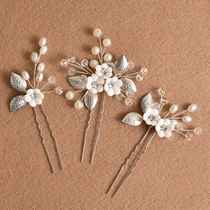 Handmade bridal hair pin set with white ceramic flowers, pearls, and crystals on silver wire