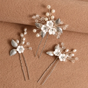 Set of three white ceramic flower bridal hair pins with silver leaves and pearls