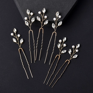 Close-up of 6-piece U-shaped hair pins with gold finish, pearls, and crystals