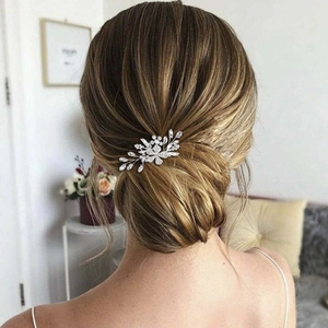 Silver flower bridal hair comb with rhinestones on an elegant low bun hairstyle