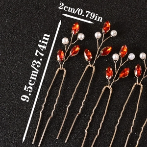 Detail of four gold U-shaped hair pins with red crystals and pearls, 9.5cm length