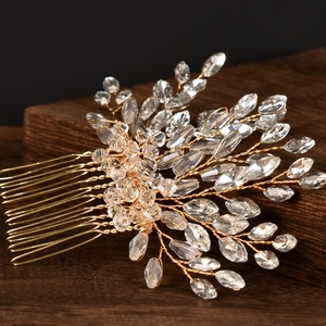 Detail of handcrafted bridal hair comb with gold wires and sparkling glass crystals