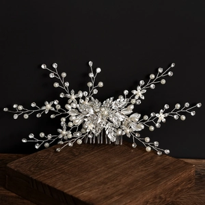 Exquisite bridal hair comb with pearls and rhinestones on a minimalist black background