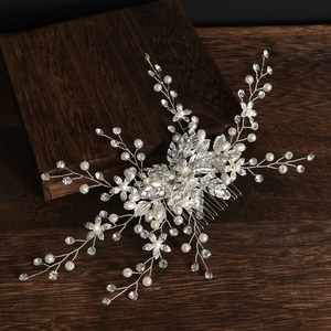 Exquisite bridal hair comb with pearls and rhinestones on silver floral leaves