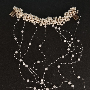 Detail view of bridal hair comb with handmade pearls and elegant cascading tassel fringes