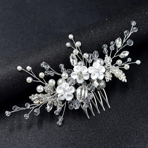 Vue détaillée du peigne de mariée avec fleurs en céramique blanche et perles cristal