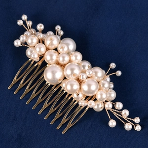 Close-up of elegant handmade gold bridal hair comb with layered white pearls