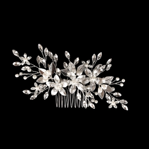 Detailed macro view of handmade bridal hair comb with silver flowers and rhinestones