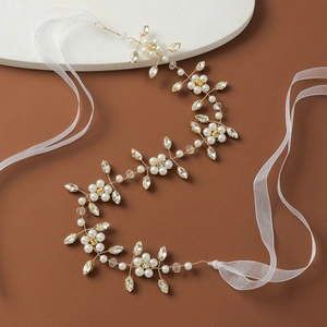 Elegant bridal hair band with white pearls, crystals, and gold wire for wedding dresses