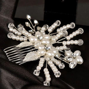 Elegant bridal hair comb featuring white pearls, crystals, and silver metal leaves