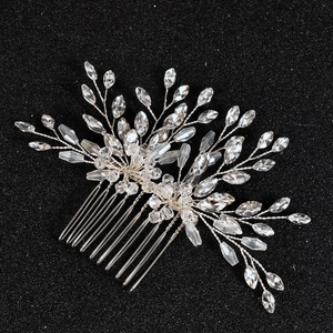 Detailed view of silver bridal hair comb with crystal leaf vine and rhinestone accents
