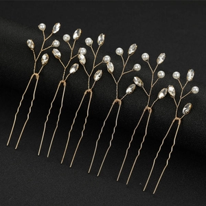 Detail showing 6-piece gold floral hair pins set with white pearls and sparkling crystals