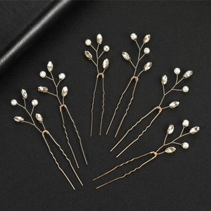 Detailed macro view of 6-piece golden branch hair pins with pearls and emerald-cut rhinestones