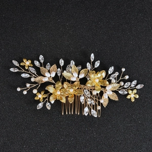 Detailed macro view of golden metal flowers with pearls and crystal rhinestones on hair comb