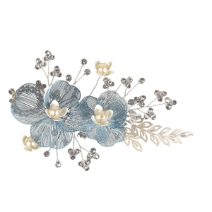 Detailed close-up of handmade blue wire petals and white pearls bridal hair clip