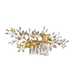 Macro detail of bridal hair comb showing handmade metal flowers, rhinestones and pearls