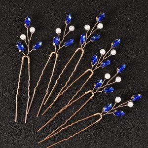 Detail of 6pcs gold wire bridal hair pins with blue crystals and pearls on black background