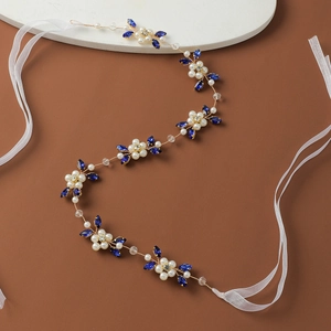 Detail of handmade bridal headband with blue crystals, pearls and golden wire ties