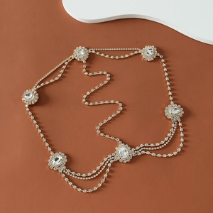 Bohemian gold multi-layer rhinestone head chain with oval crystals on warm background