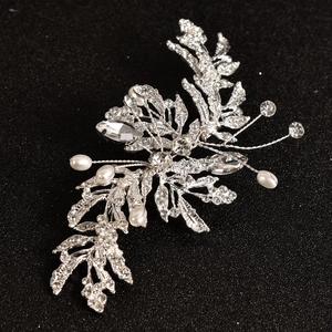 Silver bridal brooch with sparkling rhinestones and pearls in a delicate leaf branch design
