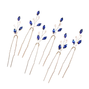 Detail view of 6-piece bridal hair pin set with emerald blue crystals and white pearls